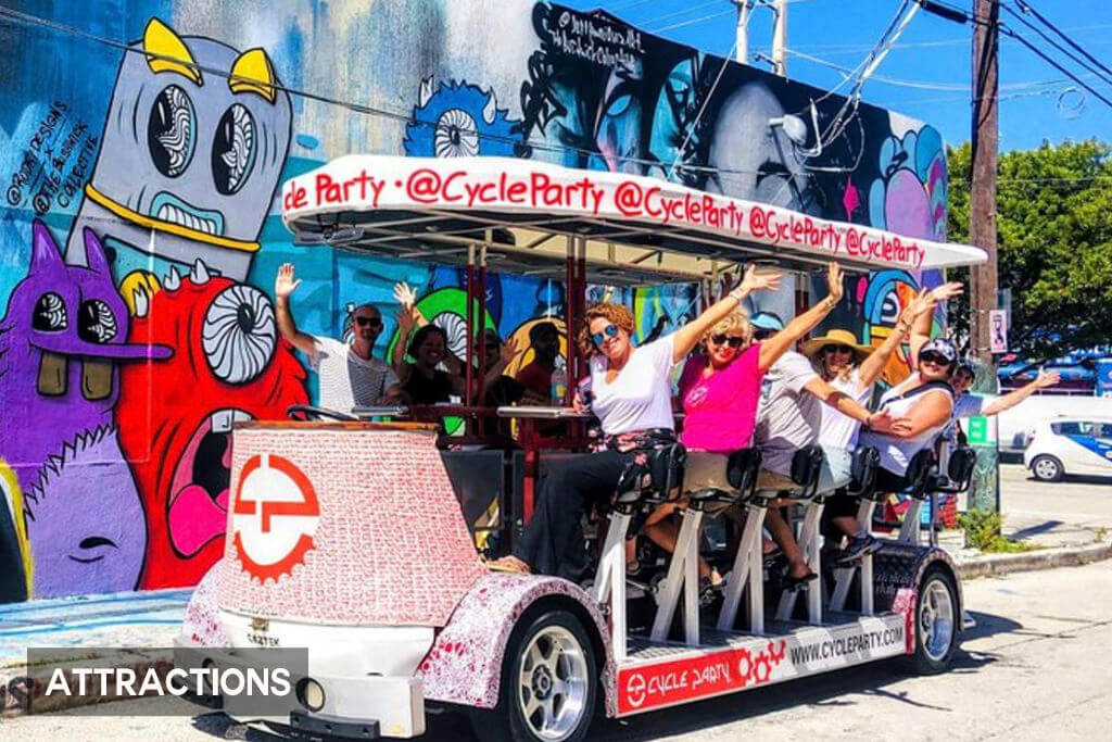 A group enjoys a Wynwood Cycle Party Bar Crawl through the streets of Miami